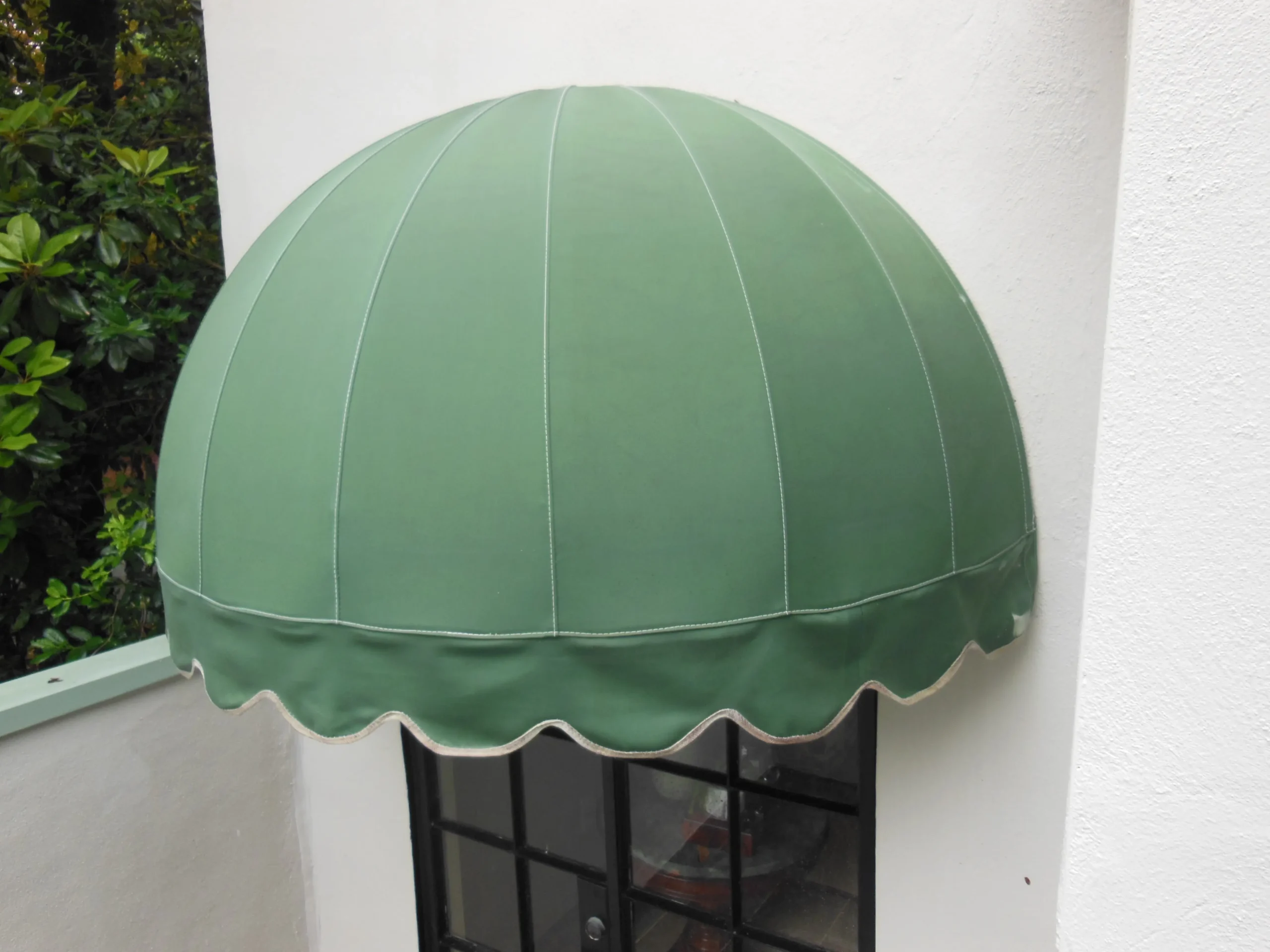 After, when repair was finished and the fabric retied to the frame, you can see the difference in how the fabric lays on the frame. After the repair was completed, the awning was cleaning and sealed.