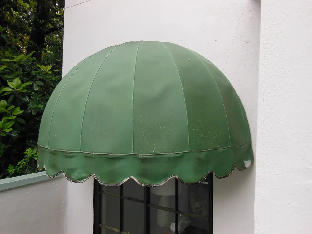 Before, this fixed half dome awning at a home in Atlanta, is in need of being re-tuned but required a repair that needed the fabric to be unlaced.